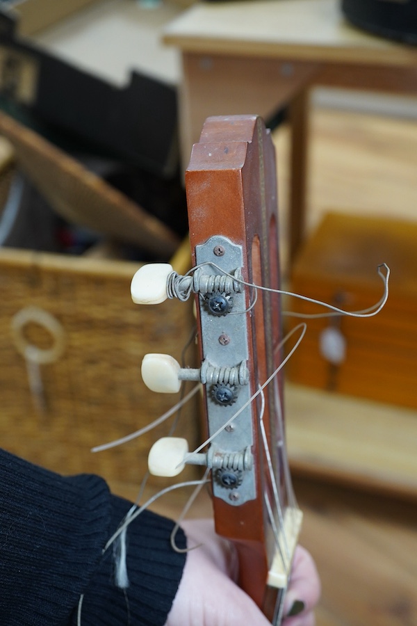 A Suzuki classical guitar, no.3067. Condition - fair, one string missing and scratches to the body.